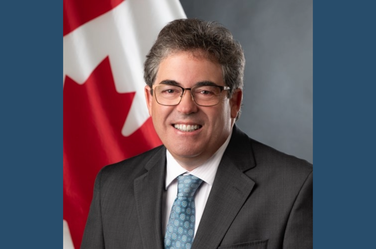 Portrait of man in front of Canadian flag